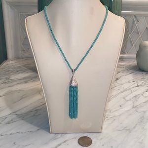 Beaded long necklace features Silvertone rhinestone casing and beaded tassel